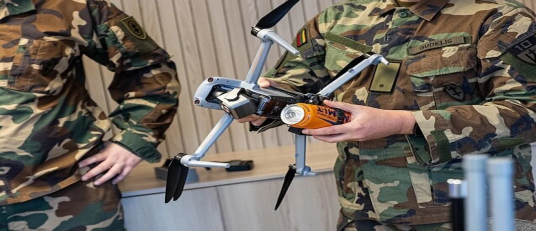 A soldier holds a drone
